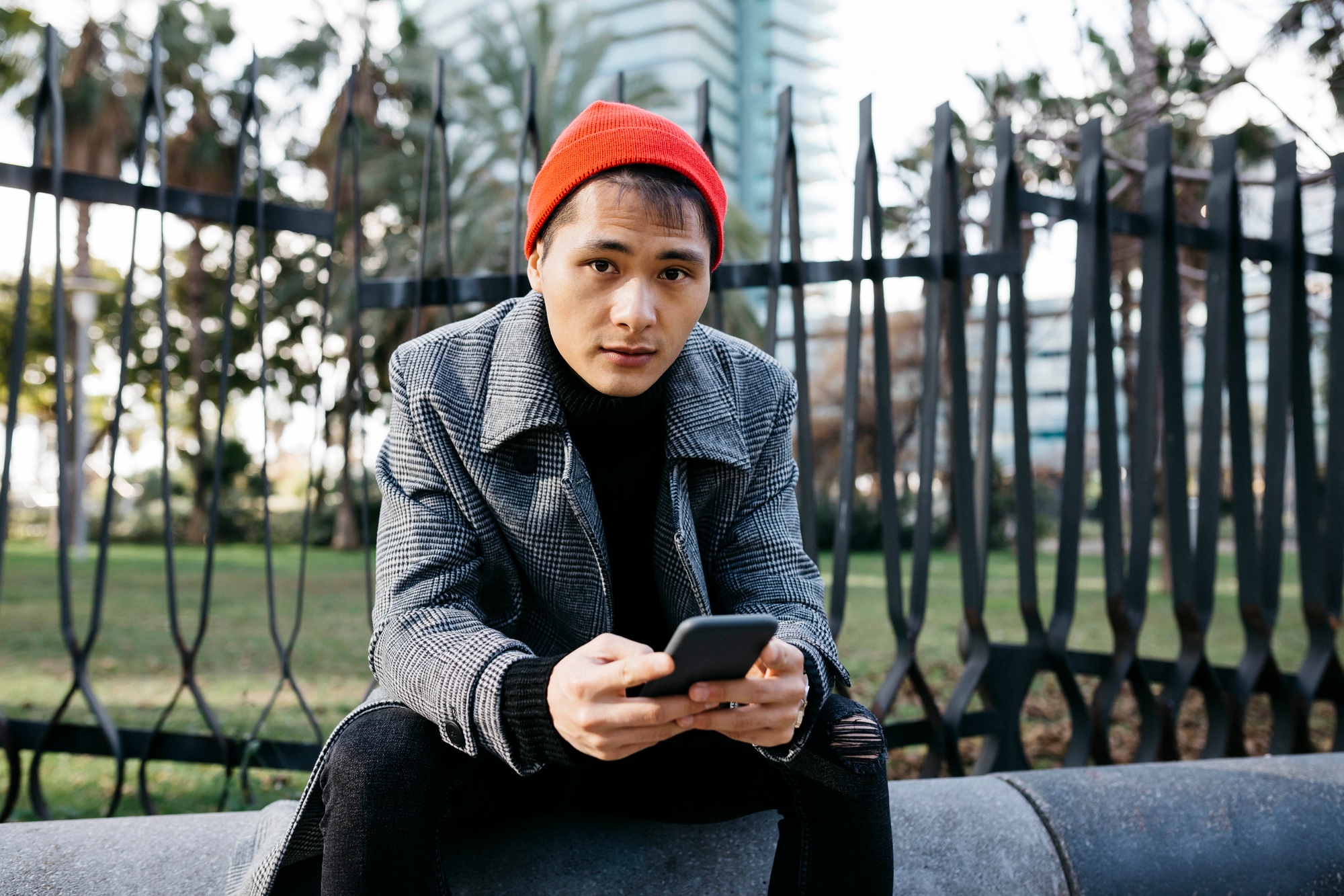 Spain, Barcelona, portrait of fashionable young man with cell phone